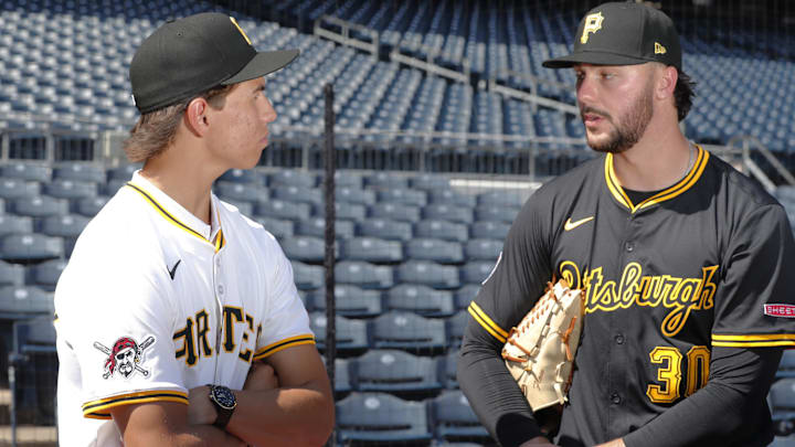 Jul 22, 2025; Pittsburgh, Pennsylvania, USA;  Seth Hernandez (left) the Pittsburgh Pirates first round and number six overall pick in the 2025 first year player draft talks with Pirates pitcher Paul Skenes (30) before the game against the Detroit Tigers at PNC Park. Mandatory Credit: Charles LeClaire-Imagn Images