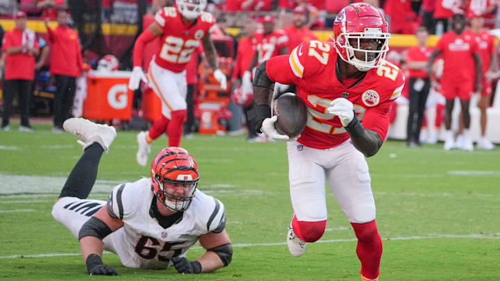 Sep 15, 2024; Kansas City, Missouri, USA; Kansas City Chiefs safety Chamarri Conner (27) recovers a fumble and runs in for a touchdown as Cincinnati Bengals guard Alex Cappa (65) misses the tackle during the second half at GEHA Field at Arrowhead Stadium. Mandatory Credit: Denny Medley-Imagn Images