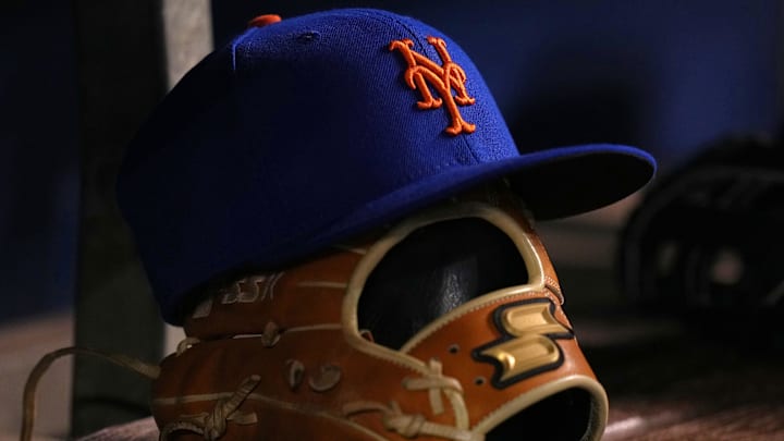 Aug 2, 2021; Miami, Florida, USA;  detailed view of the cap and glove of New York Mets shortstop Javier Baez (not pictured) in the dugout prior to the game against the Miami Marlins at loanDepot park. Mandatory Credit: Jasen Vinlove-Imagn Images