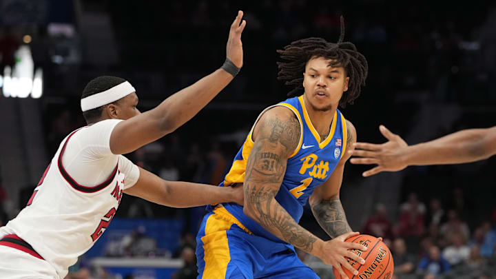 Mar 11, 2026; Charlotte, NC, USA; Pittsburgh Panthers forward Cameron Corhen (2) with the ball as NC State Wolfpack forward Ven-Allen Lubin (22) defends in the first half at Spectrum Center. Mandatory Credit: Bob Donnan-Imagn Images