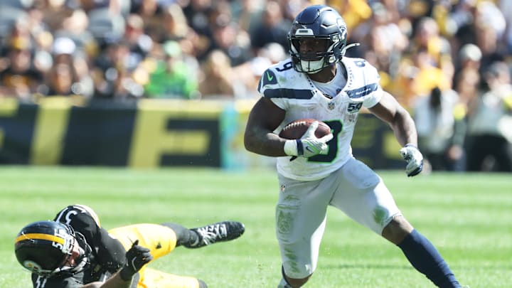 Sep 14, 2025; Pittsburgh, Pennsylvania, USA;  Seattle Seahawks running back Kenneth Walker III (9) runs the ball past Pittsburgh Steelers linebacker Nick Herbig (51) during the fourth quarter at Acrisure Stadium. Mandatory Credit: Charles LeClaire-Imagn Images