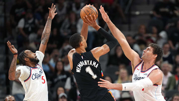 Mar 6, 2026; San Antonio, Texas, USA; San Antonio Spurs forward Victor Wembanyama (1) shoots while defended by Los Angeles Clippers center Brook Lopez (11) and guard Derrick Jones Jr. (5) during the first half at Frost Bank Center. Mandatory Credit: Scott Wachter-Imagn Images