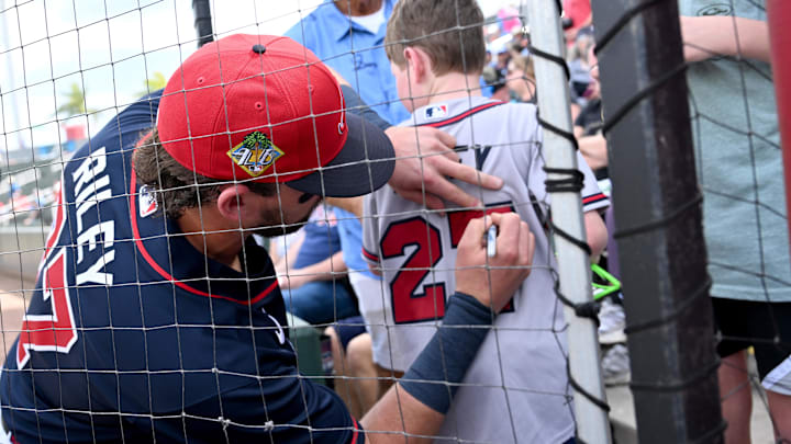 Feb 27, 2026; North Port, Florida, USA; Atlanta Braves third baseman Austin Riley (27) signs a jersey before the start of the game against the Boston Red Sox during spring training at CoolToday Park. Mandatory Credit: Jonathan Dyer-Imagn Images
