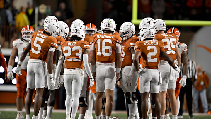 Dec 21, 2024; Austin, Texas, USA; Texas Longhorns wide receiver Ryan Wingo (5) and running back Jaydon Blue (23) and quarterback Arch Manning (16) and wide receiver Matthew Golden (2) huddle with the team during the game between the Texas Longhorns and the Clemson Tigers in the CFP National Playoff First Round at Darrell K Royal-Texas Memorial Stadium. Mandatory Credit: Jerome Miron-Imagn Images