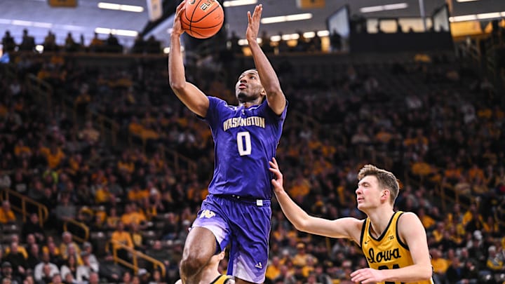 Feb 22, 2025; Iowa City, Iowa, USA; Washington Huskies guard Mekhi Mason (0) goes to the basket as Iowa Hawkeyes forward Pryce Sandfort (24) defends during the first half at Carver-Hawkeye Arena. Mandatory Credit: Jeffrey Becker-Imagn Images
