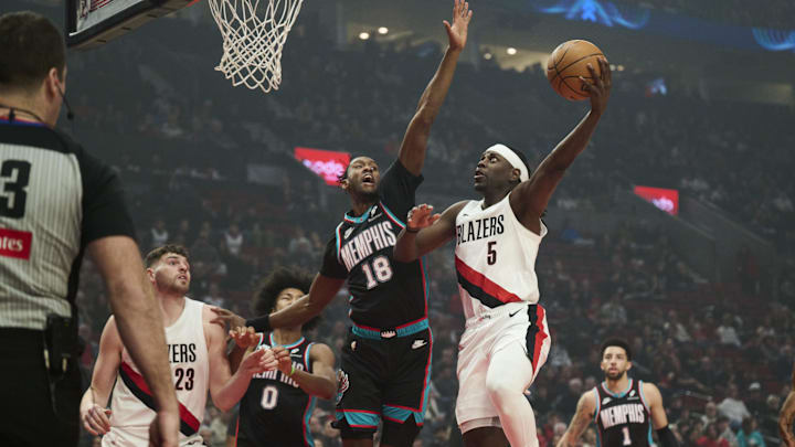 Feb 6, 2026; Portland, Oregon, USA; Portland Trail Blazers guard Jrue Holiday (5) drives to the basket during the first half against Memphis Grizzlies forward Olivier-Maxence Prosper (18) at Moda Center. Mandatory Credit: Troy Wayrynen-Imagn Images