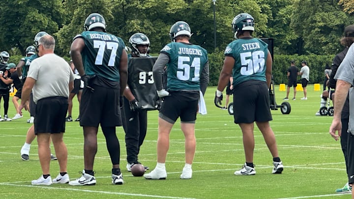 Philadelphia Eagles interior linemen prepare for a drill under O-line coach Jeff Stoutland (left). From left to right: Mekhi Becton, Cam Jurgens, and Tyler Steen. Philadelphia Eagles interior linemen prepare for a drill under O-line coach Jeff Stoutland (left). From left to right: Mekhi Becton, Cam Jurgens, and Tyler Steen.