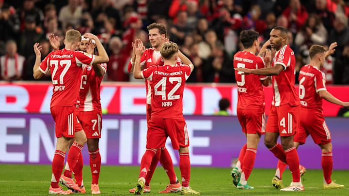 Bayern Munich players celebrating a goal against Bayer Leverkusen.