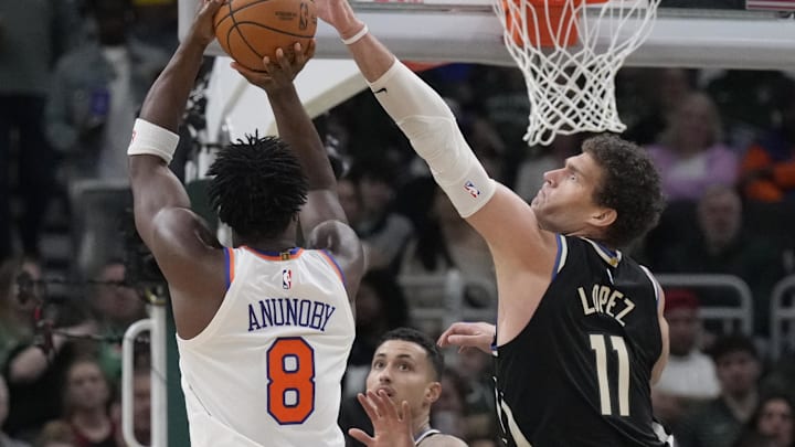Mar 28, 2025; Milwaukee, Wisconsin, USA; Milwaukee Bucks center Brook Lopez (11) attempts to block the shot of New York Knicks forward OG Anunoby (8) in the first half at Fiserv Forum. Mandatory Credit: Michael McLoone-Imagn Images