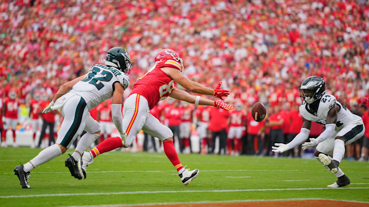 Sep 14, 2025; Kansas City, Missouri, USA; Philadelphia Eagles safety Andrew Mukuba (24) intercepts a pass intended for Kansas City Chiefs tight end Travis Kelce (87) during the fourth quarter of the game at GEHA Field at Arrowhead Stadium. Mandatory Credit: Jay Biggerstaff-Imagn Images