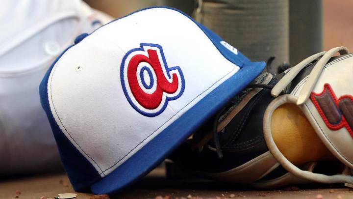Aug 2, 2019; Atlanta, GA, USA; An Atlanta Braves throw back hat is shown with a glove in the dugout during the fifth inning against Cincinnati Reds at SunTrust Park. Mandatory Credit: Jason Getz-Imagn Images Aug 2, 2019; Atlanta, GA, USA; An Atlanta Braves throw back hat is shown with a glove in the dugout during the fifth inning against Cincinnati Reds at SunTrust Park. Mandatory Credit: Jason Getz-Imagn Images