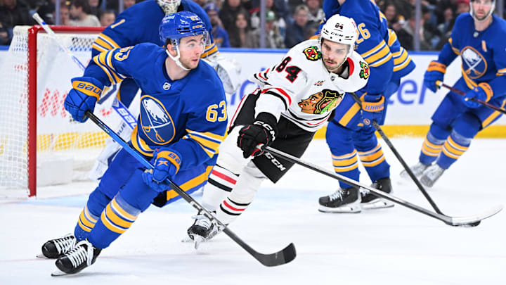 Buffalo Sabres right wing Isak Rosen (63) moves the puck away from Chicago Blackhawks left wing Landon Slaggert (84) at KeyBank Center. 