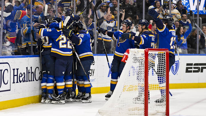 Mar 20, 2025; St. Louis, Missouri, USA;  St. Louis Blues defenseman Philip Broberg (6) is congratulated by teammates after scoring the game winning goal against the Vancouver Canucks in overtime at Enterprise Center. Mandatory Credit: Jeff Curry-Imagn Images
