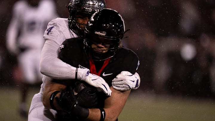 TCU Horned Frogs linebacker Namdi Obiazor (4) tackles Cincinnati Bearcats tight end Joe Royer (11) in the third quarter of the NCAA football game between Cincinnati Bearcats and TCU Horned Frogs at Nippert Stadium in Cincinnati on Saturday, Nov. 30, 2024. TCU Horned Frogs linebacker Namdi Obiazor (4) tackles Cincinnati Bearcats tight end Joe Royer (11) in the third quarter of the NCAA football game between Cincinnati Bearcats and TCU Horned Frogs at Nippert Stadium in Cincinnati on Saturday, Nov. 30, 2024.