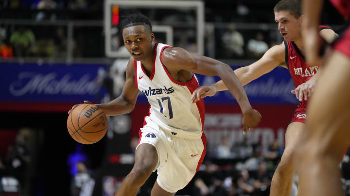 Jul 12, 2024; Las Vegas, NV, USA;  Washington Wizards guard Bub Carrington (17) drives the ball against Atlanta Hawks guard Nikola Durisic (7) during the second half at Thomas & Mack Center. Mandatory Credit: Lucas Peltier-USA TODAY Sports