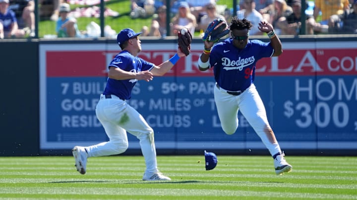 Feb 23, 2025; Phoenix, Arizona, USA; Los Angeles Dodgers outfielder Tommy Edman (25) makes a catch on a pop-up while avoiding teammate right fielder Zyhir Hope (94) during the third inning at Camelback Ranch-Glendale. Mandatory Credit: Joe Camporeale-Imagn Images Feb 23, 2025; Phoenix, Arizona, USA; Los Angeles Dodgers outfielder Tommy Edman (25) makes a catch on a pop-up while avoiding teammate right fielder Zyhir Hope (94) during the third inning at Camelback Ranch-Glendale. Mandatory Credit: Joe Camporeale-Imagn Images