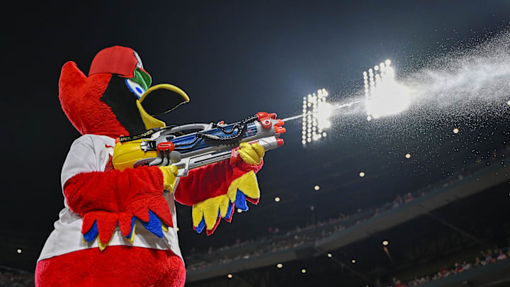 Jul 28, 2023; St. Louis, Missouri, USA;  St. Louis Cardinals mascot Fredbird sprays water on a fan during the eighth inning against the Chicago Cubs at Busch Stadium. Mandatory Credit: Jeff Curry-Imagn Images
