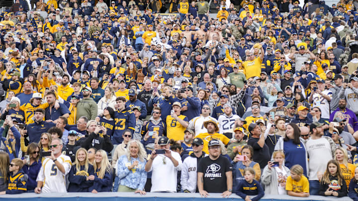 Nov 8, 2025; Morgantown, West Virginia, USA; West Virginia Mountaineers fans sing “Country Roads” after defeating the Colorado Buffaloes at Milan Puskar Stadium. Mandatory Credit: Ben Queen-Imagn Images