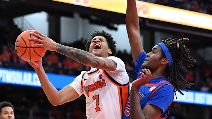 Feb 14, 2026; Syracuse, New York, USA; Syracuse Orange forward Kiyan Anthony (7) is fouled by Southern Methodist University Mustangs center Jaden Toombs (10) during a shot in the second half at the JMA Wireless Dome. Mandatory Credit: Mark Konezny-Imagn Images