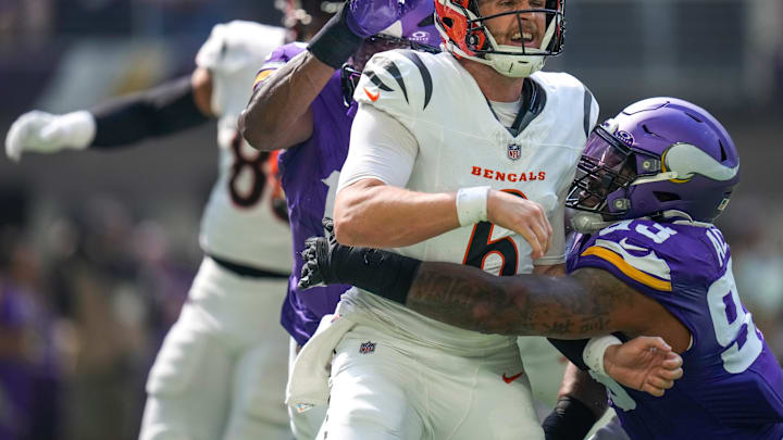 Cincinnati Bengals quarterback Jake Browning (6) is knocked down by Minnesota Vikings defensive tackle Jonathan Allen (93) as he gets a pass off in the second quarter of the NFL Week 3 game between the Minnesota Vikings and the Cincinnati Bengals at U.S. Bank Stadium in Minneapolis on Sunday, Sept. 21, 2025.