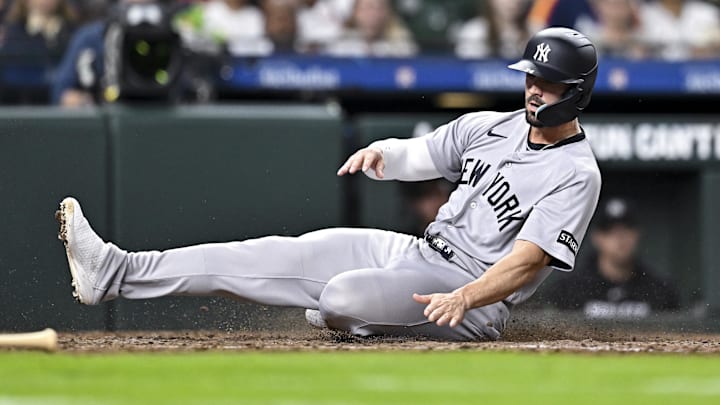 New York Yankees right fielder Randal Grichuk (34) sliding safely into home in the seventh inning against the Houston Astros at Daikin Park.