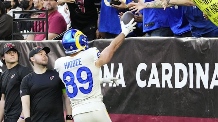 Los Angeles Rams tight end Tyler Higbee (89) hands the ball to a Rams fan after making a touchdown against the Arizona Cardinals in the first half at State Farm Stadium in Glendale on Nov. 26, 2023. Los Angeles Rams tight end Tyler Higbee (89) hands the ball to a Rams fan after making a touchdown against the Arizona Cardinals in the first half at State Farm Stadium in Glendale on Nov. 26, 2023.