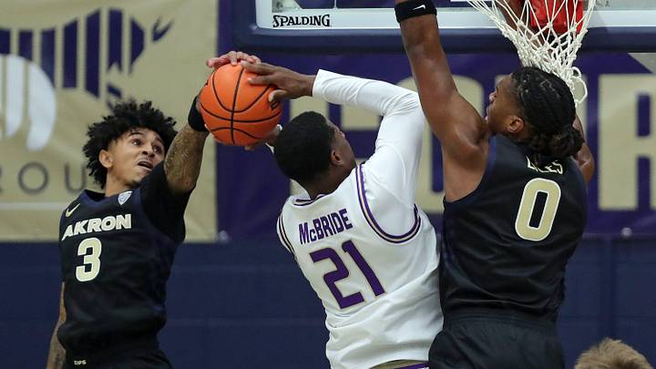Akron Zips guard Sharron Young (3) and forward Amani Lyles (0) work to block James Madison Dukes forward Justin McBride (21) during the first half of an NCAA college basketball game at James A. Rhodes Arena, Nov. 3, 2025, in Akron, Ohio Akron Zips guard Sharron Young (3) and forward Amani Lyles (0) work to block James Madison Dukes forward Justin McBride (21) during the first half of an NCAA college basketball game at James A. Rhodes Arena, Nov. 3, 2025, in Akron, Ohio