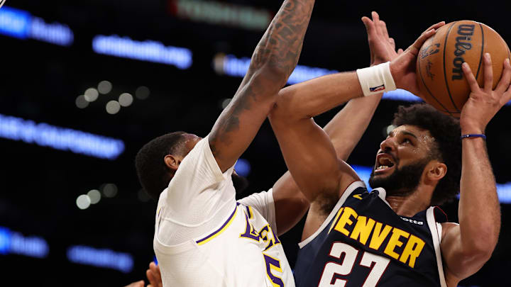 Nov 23, 2024; Los Angeles, California, USA:  Denver Nuggets guard Jamal Murray (27) goes to the basket against Los Angeles Lakers forward Cam Reddish (5) during the second quarter at Crypto.com Arena. Mandatory Credit: Kiyoshi Mio-Imagn Images