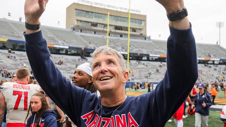 Oct 10, 2026; Morgantown, West Virginia, USA; Arizona Wildcats head coach Brent Brennan celebrates with fans after defeating the West Virginia Mountaineers at Milan Puskar Stadium. Oct 10, 2026; Morgantown, West Virginia, USA; Arizona Wildcats head coach Brent Brennan celebrates with fans after defeating the West Virginia Mountaineers at Milan Puskar Stadium.