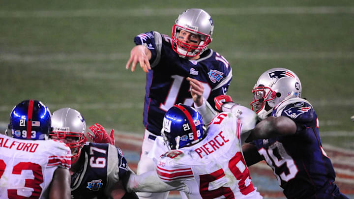 Feb 3, 2008; Glendale, AZ, USA; New England Patriots quarterback (12) Tom Brady against the New York Giants during Super Bowl XLII at the University of Phoenix Stadium.  Mandatory Credit: Mark J. Rebilas-Imagn Images