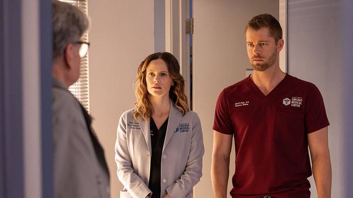 CHICAGO MED -- "The Book of Charles" Episode 1115 -- Pictured: (l-r) Sarah Ramos as Dr. Caitlin Lenox, Luke Mitchell as Dr. Mitch Ripley