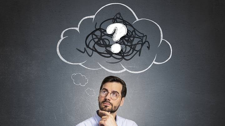 Man thinking with question mark drawing above head Man thinking with question mark drawing above head