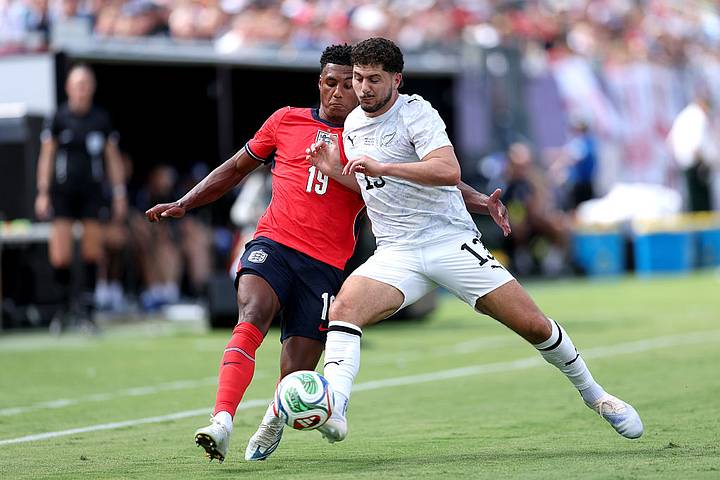 Ollie Watkins of England battles for possession with Liberato Cacace of New Zealand.