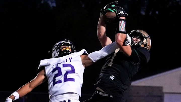 West’s Ethan Headings (1) makes a catch contested by Liberty’s Adrian Clerry (22) during a high school football game Sept. 26, 2025 at Iowa City West in Iowa City, Iowa.