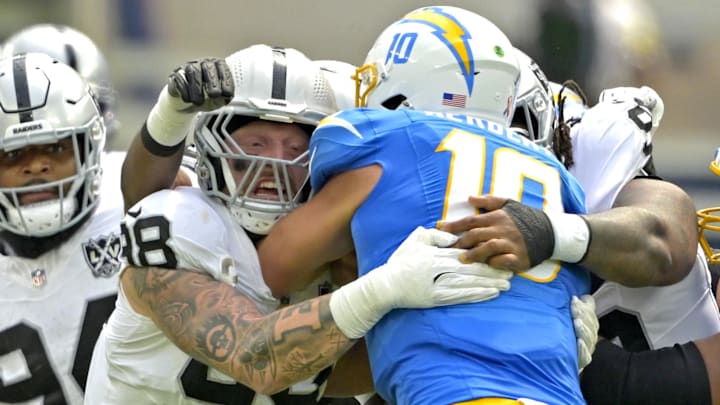 Sep 8, 2024; Inglewood, California, USA;Los Angeles Chargers quarterback Justin Herbert (10) is sacked by Las Vegas Raiders defensive end Maxx Crosby (98) in the first half at SoFi Stadium. Mandatory Credit: Jayne Kamin-Oncea-Imagn Images Sep 8, 2024; Inglewood, California, USA;Los Angeles Chargers quarterback Justin Herbert (10) is sacked by Las Vegas Raiders defensive end Maxx Crosby (98) in the first half at SoFi Stadium. Mandatory Credit: Jayne Kamin-Oncea-Imagn Images