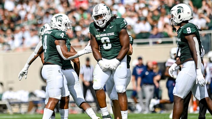 Michigan State's Simeon Barrow Jr., center, celebrates his sack against Richmond during the first quarter on Saturday, Sept. 9, 2023, at Spartan Stadium in East Lansing.