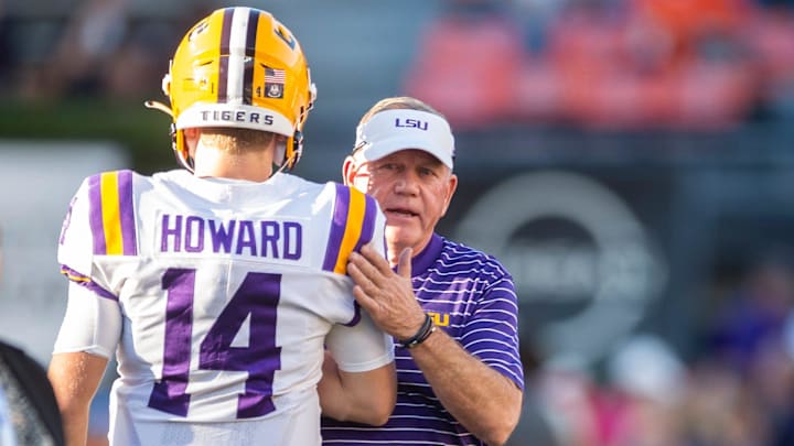 LSU Tigers head coach Brian Kelly talks with LSU Tigers quarterback Walker Howard (14) during warm ups before Auburn Tigers take on LSU Tigers at Jordan-Hare Stadium in Auburn, Ala., on Saturday, Oct. 1, 2022.