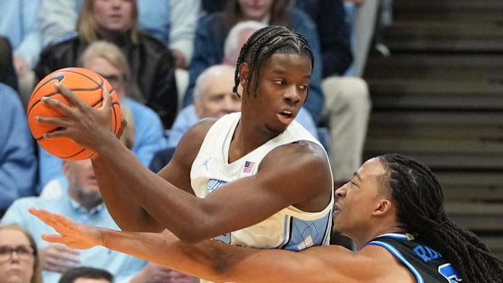 Feb 7, 2026; Chapel Hill, North Carolina, USA;  North Carolina Tar Heels forward Caleb Wilson (8) with the ball as Duke Blue Devils forward Maliq Brown (6) defends in the first half at Dean E. Smith Center. Mandatory Credit: Bob Donnan-Imagn Images