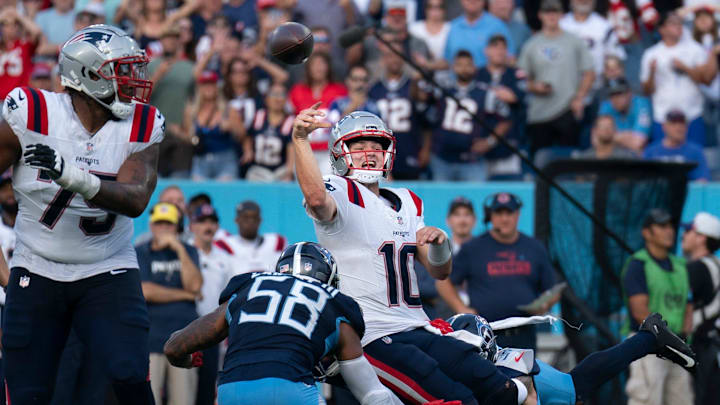 New England Patriots quarterback Drake Maye (10) throws while in the grasp of Tennessee Titans safety Mike Brown (44) during their game at Nissan Stadium in Nashville, Tenn., Sunday, Nov. 3, 2024. It was the last play of regulation and the New England Patriots running back Rhamondre Stevenson (38) came up with the reception in the end zone to force overtime. The play lasted more than 11 seconds as Mayes kept the play alive under constant pressure.