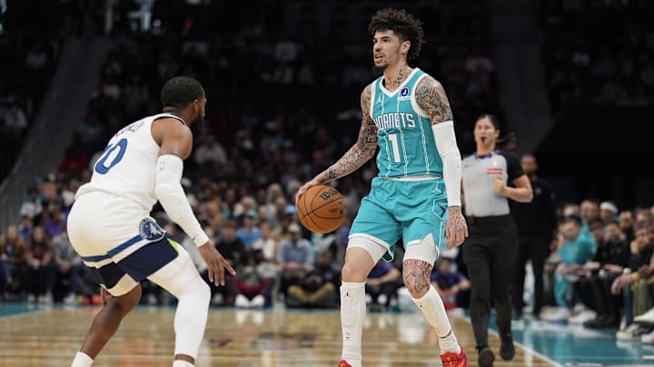 Nov 1, 2025; Charlotte, North Carolina, USA; Charlotte Hornets guard LaMelo Ball (1) sets the play defended by Minnesota Timberwolves guard Mike Conley (10) during the first quarter at Spectrum Center. Mandatory Credit: Jim Dedmon-Imagn Images