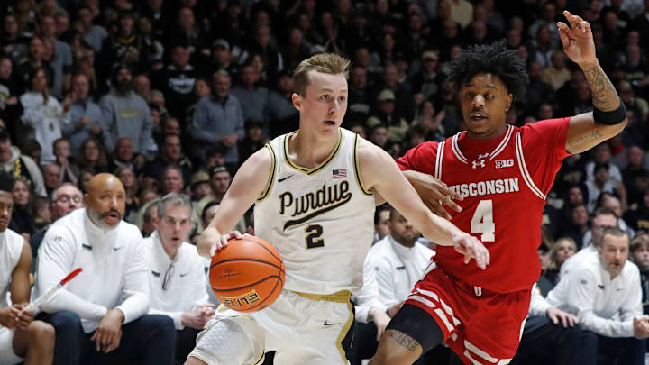 Purdue Boilermakers guard Fletcher Loyer (2) drives past Wisconsin Badgers guard Kamari McGee (4)