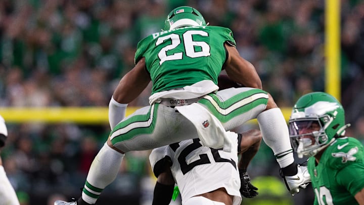 Nov 3, 2024; Philadelphia, Pennsylvania, USA; Philadelphia Eagles running back Saquon Barkley (26) leaps with the ball over Jacksonville Jaguars cornerback Jarrian Jones (22) during the second quarter at Lincoln Financial Field. Mandatory Credit: Bill Streicher-Imagn Images