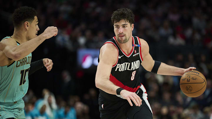Feb 22, 2025; Portland, Oregon, USA; Portland Trail Blazers forward Deni Avdija (8) dribbles the ball during the second half against Charlotte Hornets guard Josh Green (10) at Moda Center. Mandatory Credit: Troy Wayrynen-Imagn Images