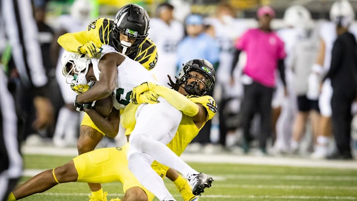 Oregon Ducks inside linebacker Jestin Jacobs, left, and defensive back Dakoda Fields, right, wrap up Michigan State Spartans wide receiver Nick Marsh as the Ducks host the Spartans Friday, Oct. 4, 2024 at Autzen Stadium in Eugene, Ore. Oregon Ducks inside linebacker Jestin Jacobs, left, and defensive back Dakoda Fields, right, wrap up Michigan State Spartans wide receiver Nick Marsh as the Ducks host the Spartans Friday, Oct. 4, 2024 at Autzen Stadium in Eugene, Ore.