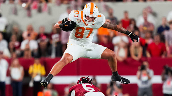 Tennessee tight end Miles Kitselman (87) hurdles Alabama defensive back Dijon Lee Jr. (5) during a college football game at Bryant-Denny Stadium in Tuscaloosa, Ala., on Oct. 18, 2025.