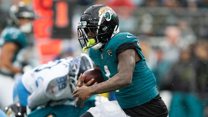 Dec 29, 2024; Jacksonville, Florida, USA; Jacksonville Jaguars running back Travis Etienne Jr (1) runs the ball against the Tennessee Titans in the first quarter at EverBank Stadium. Mandatory Credit: Jeremy Reper-Imagn Images