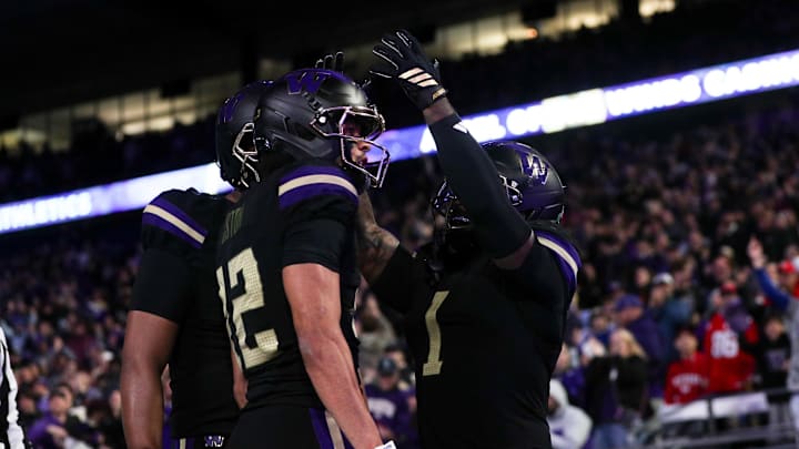Oct 10, 2025; Seattle, Washington, USA; Washington running back Jonah Coleman (1) puts an imaginary crown on wide receiver Denzel Boston (12) to celebrate a touchdown against the Rutgers Scarlet Knights during the first half at Husky Stadium. Mandatory Credit: Kevin Ng-Imagn Images