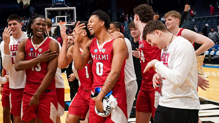 Miami (OH) RedHawks players and staff celebrate after defeating the Southern Methodist University Mustangs 89-79, Wednesday, March 18, 2026, at University of Dayton Arena in Dayton, Oh.