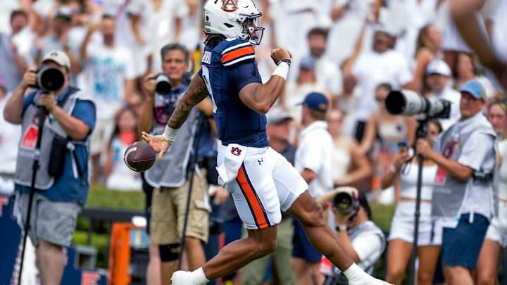 Auburn Tigers quarterback Robby Ashford (9) scores against UMass during their game at Jordan-Hare