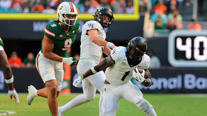 Nov 23, 2024; Miami Gardens, Florida, USA; Wake Forest Demon Deacons running back Demond Claiborne (1) runs with the football against the Miami Hurricanes during the second quarter at Hard Rock Stadium. Mandatory Credit: Sam Navarro-Imagn Images